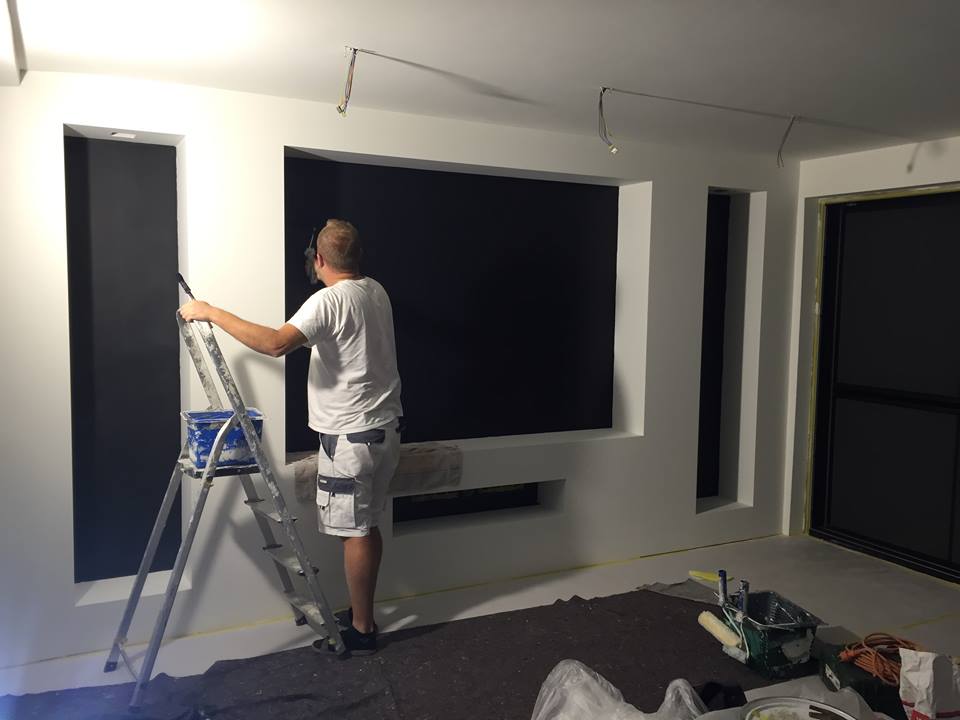 Schilder aan het werk aan een modern zwart-wit interieur